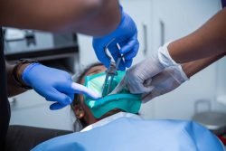 dentists doing surgery to the patient at dental care in coimbatore