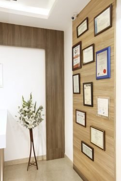 Awards and certificates placed in the wall of the dental care in coimbatore